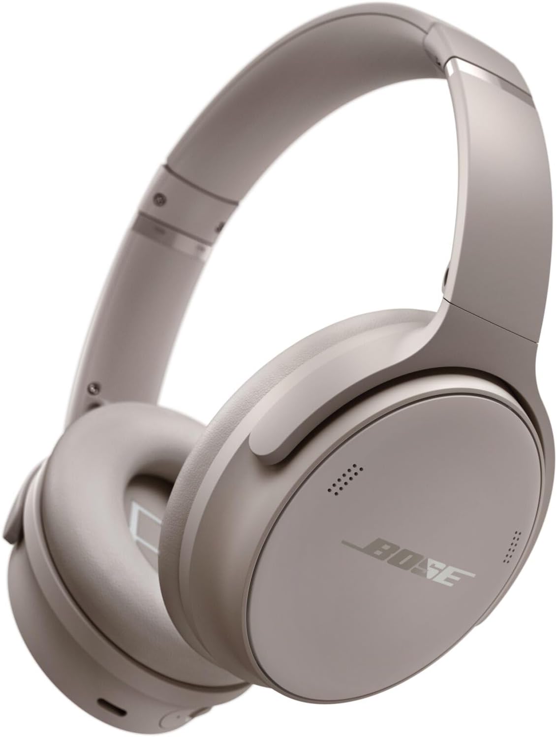 Sandstone Bose QuietComfort over-ear headphones resting on a home office desk with a stable wireless Bluetooth audio connection.